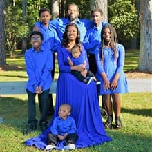 Steven Moore with his wife, Whitney, and their six children – all wearing blue.