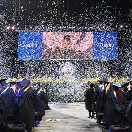 Confetti falling over graduates at the SNHU 2025 Spring Commencement