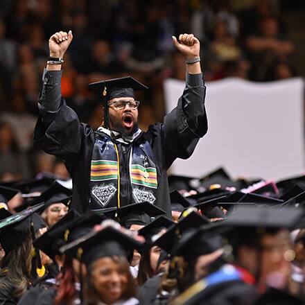 SNHU student celebrating at commencement ceremony.