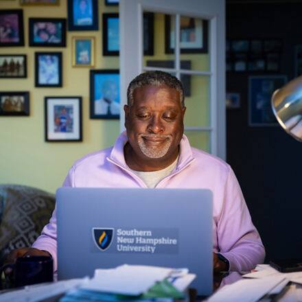 Corey Dantzler, an SNHU graduate working on his masters degree from his home desk.