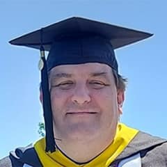 Christopher McGinnis, a 2023 graduate from SNHU with a master's in organizational leadership.