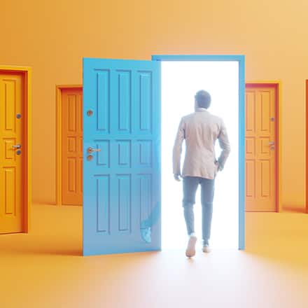 A person walking into an open blue door in a room full of orange doors.