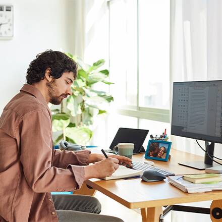 A writer sitting at his desk working on writing his novel.