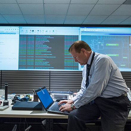 A retired police officer sitting at a desk in an office working at a new job.