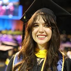 Katlyn Genovese, a SNHU criminal justice graduate dressed in her SNHU graduation cap and gown.