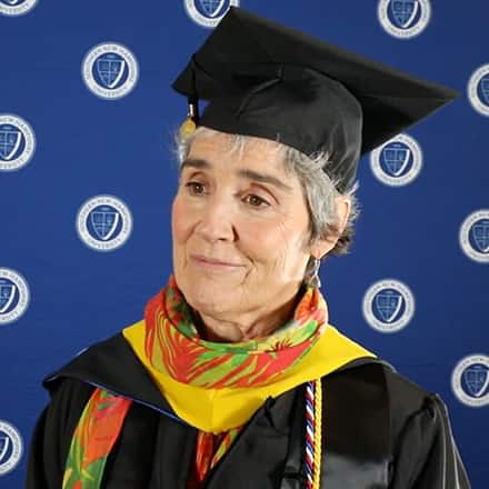 SNHU online business degree graduate and grandmother Lynda Jarrett at Commencement wearing her cap and gown.