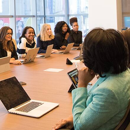 A group of public relation specialists discussing what they do while sitting at a conference table