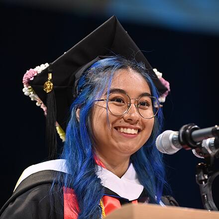 Kayleigh An Philip, an SNHU graduate with her BA in communication speaking at spring 2024 Commencement