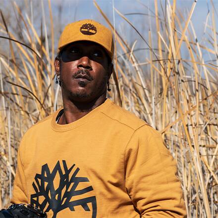 Ryan Carter, wildlife photographer, standing in tall grass.