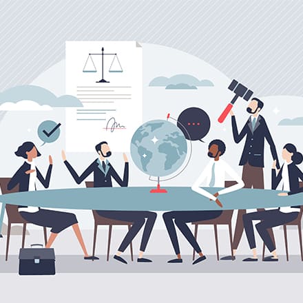 Animated professionals gathered around a globe at a conference table.