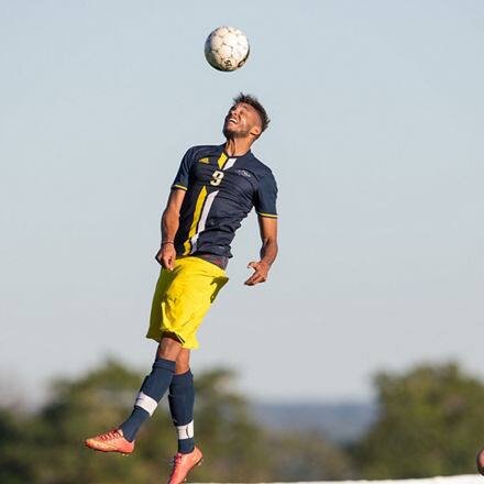 A student-athlete playing soccer