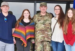 Maddie Davis, a military spouse and a recipient of a full-tuition scholarship to SNHU, with her family