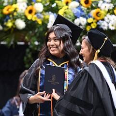 SNHU student receiving diploma.