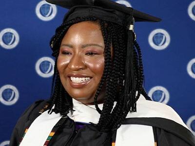 Adanze Chukwuocha, who earned her master's in English and creative writing from SNHU in 2023, wearing her graduation cap and gown.