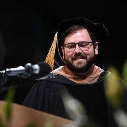 SNHU Alumni Board President Aarron Dupuis speaking at Commencement