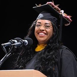 Ceisley Jefferson, a 2024 graduate from SNHU, speaking at Commencement after earning a master's in psychology