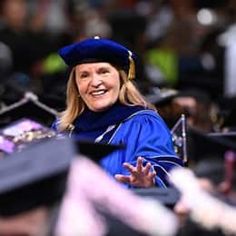 SNHU President Lisa Marsh Ryerson walking among SNHU graduates