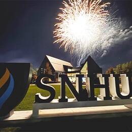 Fireworks above the Paul J. LeBlanc Hall and SNHU sign on campus