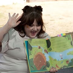 Cassi Key, an SNHU graduate with a bachelor's in English, reading a children's book about bees aloud