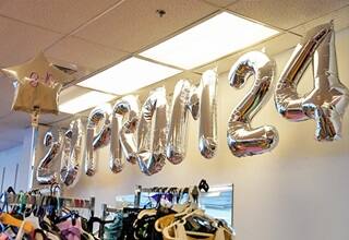 Silver balloons spelling out Prom 2024 in Missy's Closet, the site of volunteer hours during SNHU's Global Days of Service