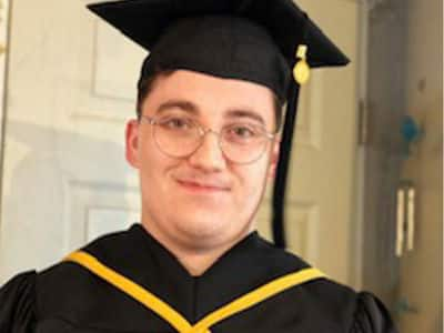 Jacob Kane-Conrad, who earned his associate in IT from SNHU in 2021, wearing his graduation cap and gown.