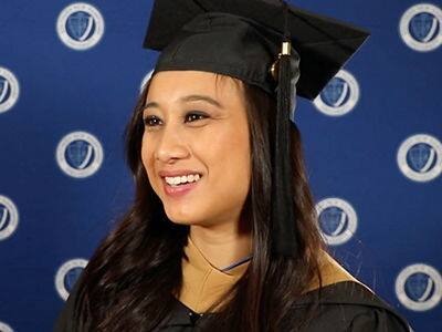 Melanie Martinez, who earned her online MBA with a concentration in music business from SNHU in 2023, wearing her graduation cap and gown.