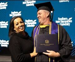 Nadine Hallisy, left, beside husband Ed Hallisy, right, who is wearing his graduation cap and gown.