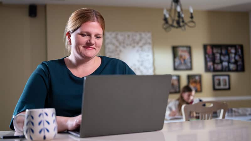 Shelly Villa 2019, an online degree graduate, working from a laptop computer.