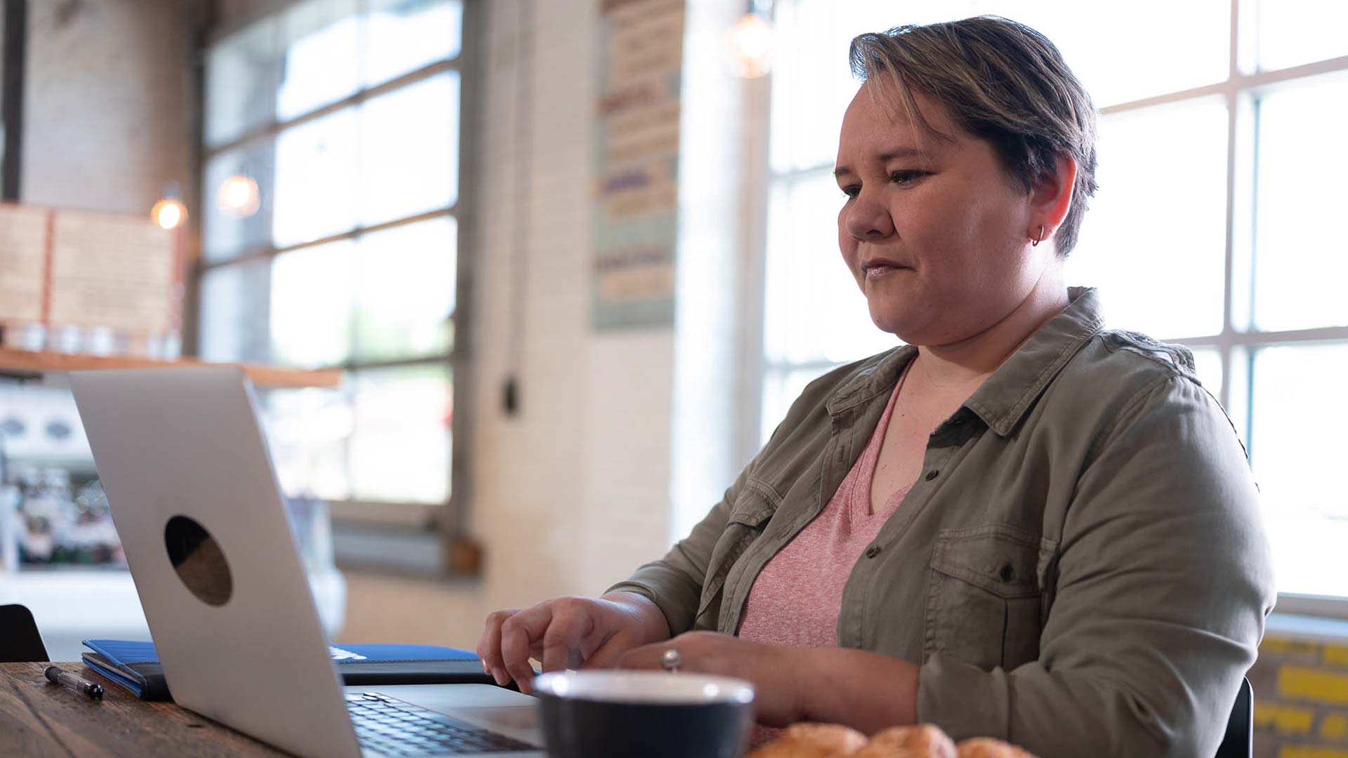 Alaine Garcia, who earned her degree from SNHU in 2019, typing on her laptop computer.