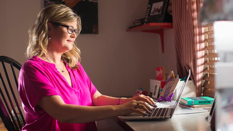 Kristina Libby, who earned her online BSN in 2017, working from a laptop at a desk.