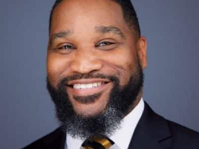 Dr. James Winfield, associate dean of SNHU's first-year experience and online general education program, wearing a dark suit and a blue and gold tie.