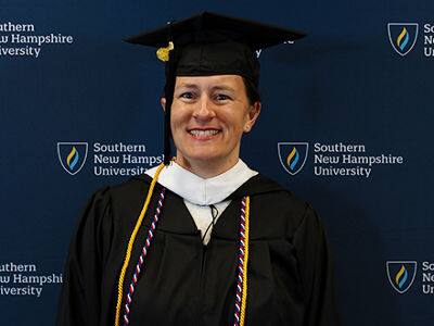 Lisa Rogers, who earned her bachelor's in anthropology from SNHU in 2024, wearing her cap and gown.