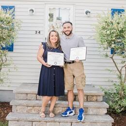 Kathleen Gagnon, left, with son Stephen Goulakos, right, holding their diplomas from SNHU.