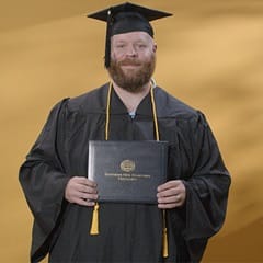 Travis Baril, a 2024 graduate who earned a bachelor’s degree in psychology from SNHU.