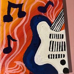 A guitar and three music notes painted on a canvas during SNHU's Homecoming Weekend