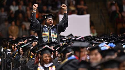 SNHU student celebrating at commencement ceremony.