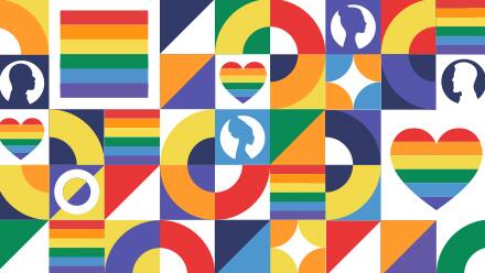 Several rainbow colored heart, icons, flags and silhouettes representing Pride Month