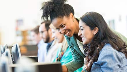 A college student and her advisor exploring BA vs BS degree programs on a desktop computer.