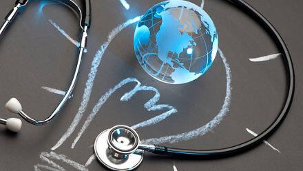 A stethoscope and a globe over a chalk illustration of a lightbulb