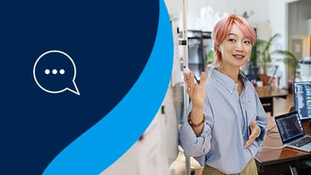 A marketer presenting to a group of people at a whiteboard with a talk bubble to the left on a blue background