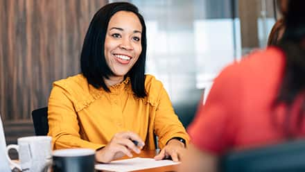 A woman speaking to another employee in her role as a human resources manager