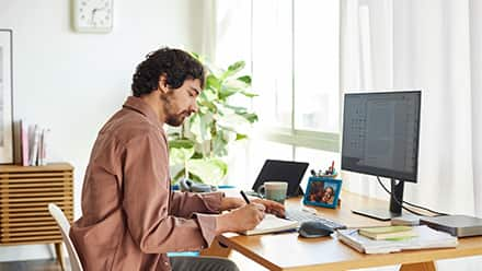 A writer sitting at his desk working on writing his novel.