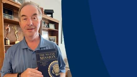 Anthony Knopps, an SNHU communication adjunct, holding his latest book, "The No-Fail Mission."