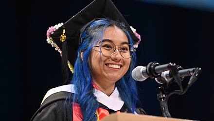 Kayleigh An Philip, an SNHU graduate with her BA in communication speaking at spring 2024 Commencement