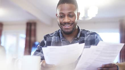 A man reads a financial award letter.