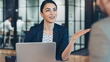 HR Lady in Blue Jacket in front laptop