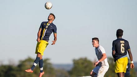 A student-athlete playing soccer