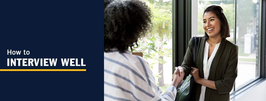 A woman shakes hands with a hiring manager and contemplates how to interview well