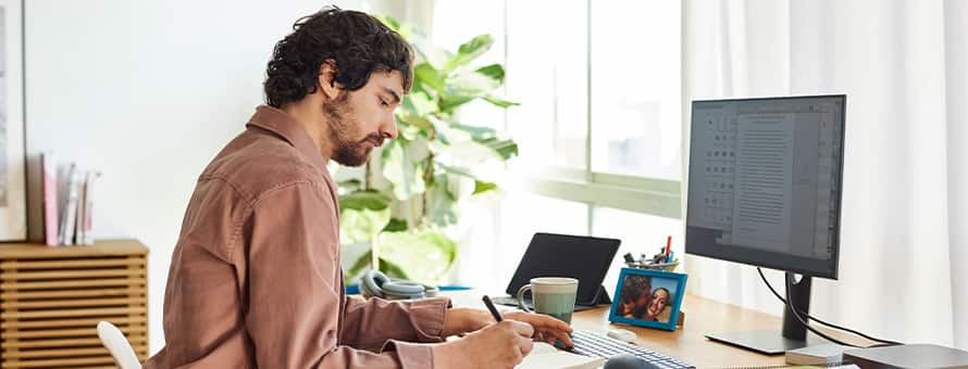 A writer sitting at his desk working on writing his novel.