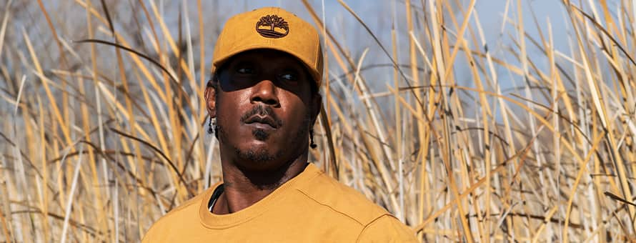 Ryan Carter, wildlife photographer, standing in tall grass.